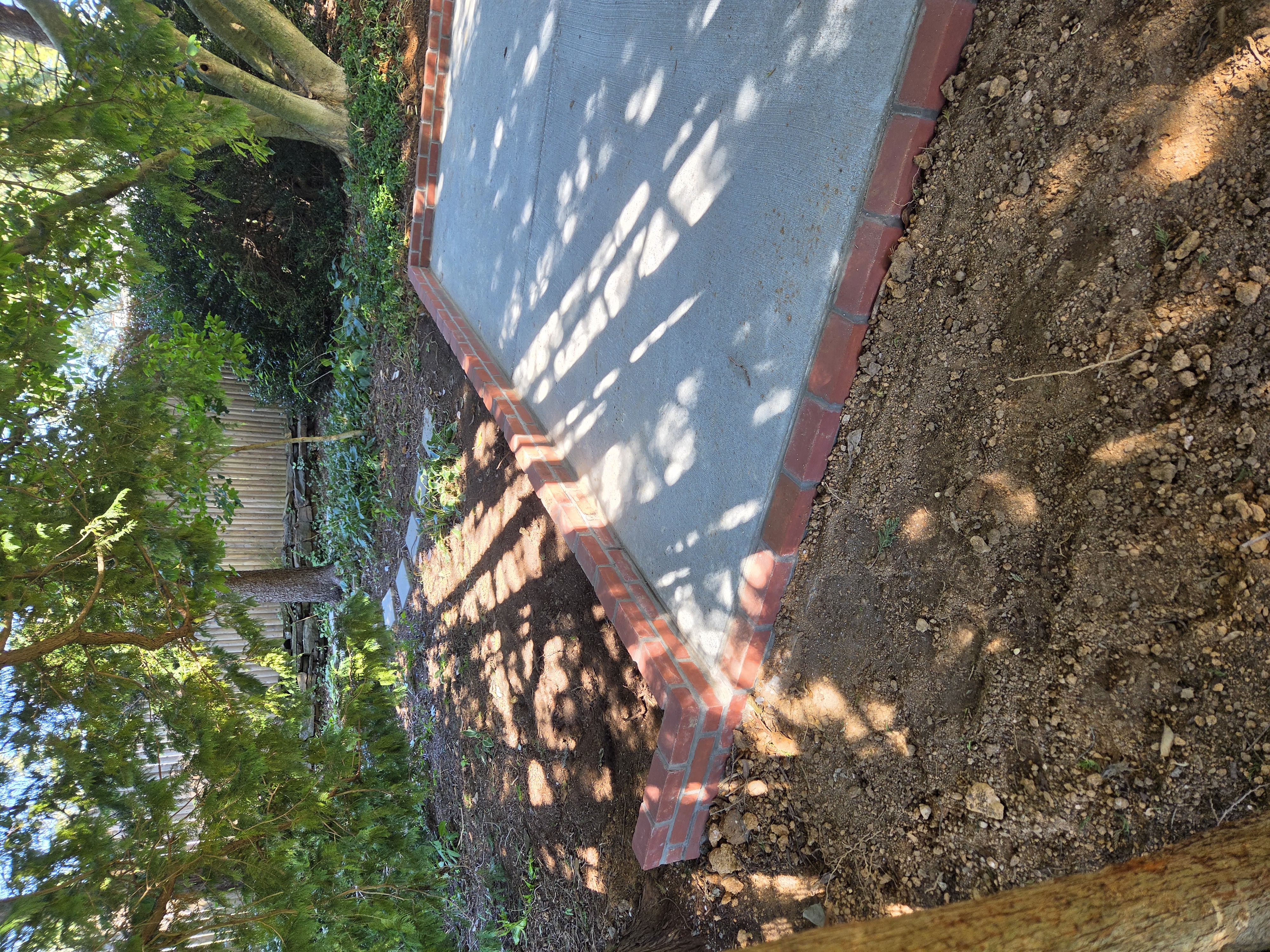Finished concrete patio with brick border in Paoli PA