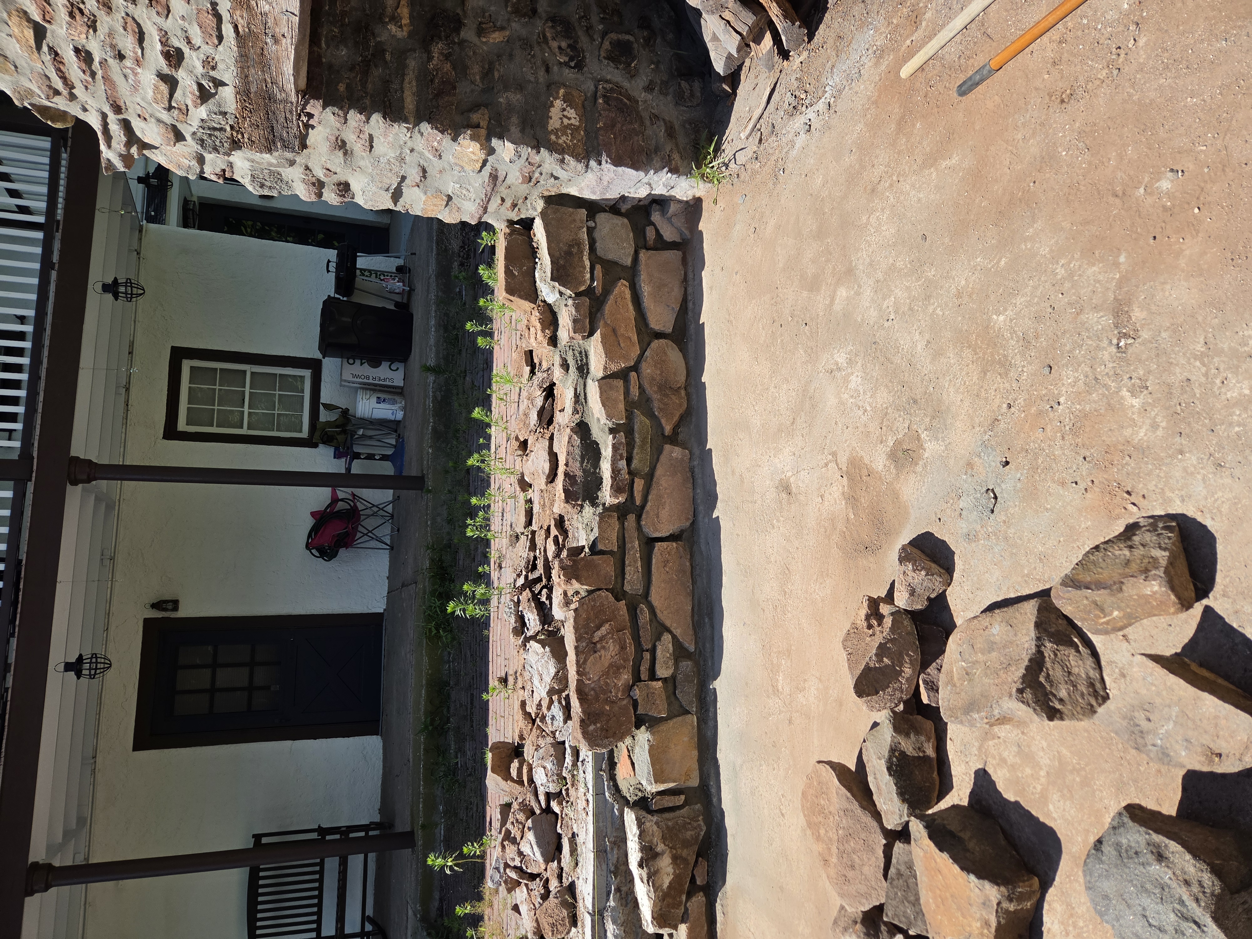 Freestanding natural stone sitting wall under construction at a historic outdoor kitchen in Birdsboro Pennsylvania