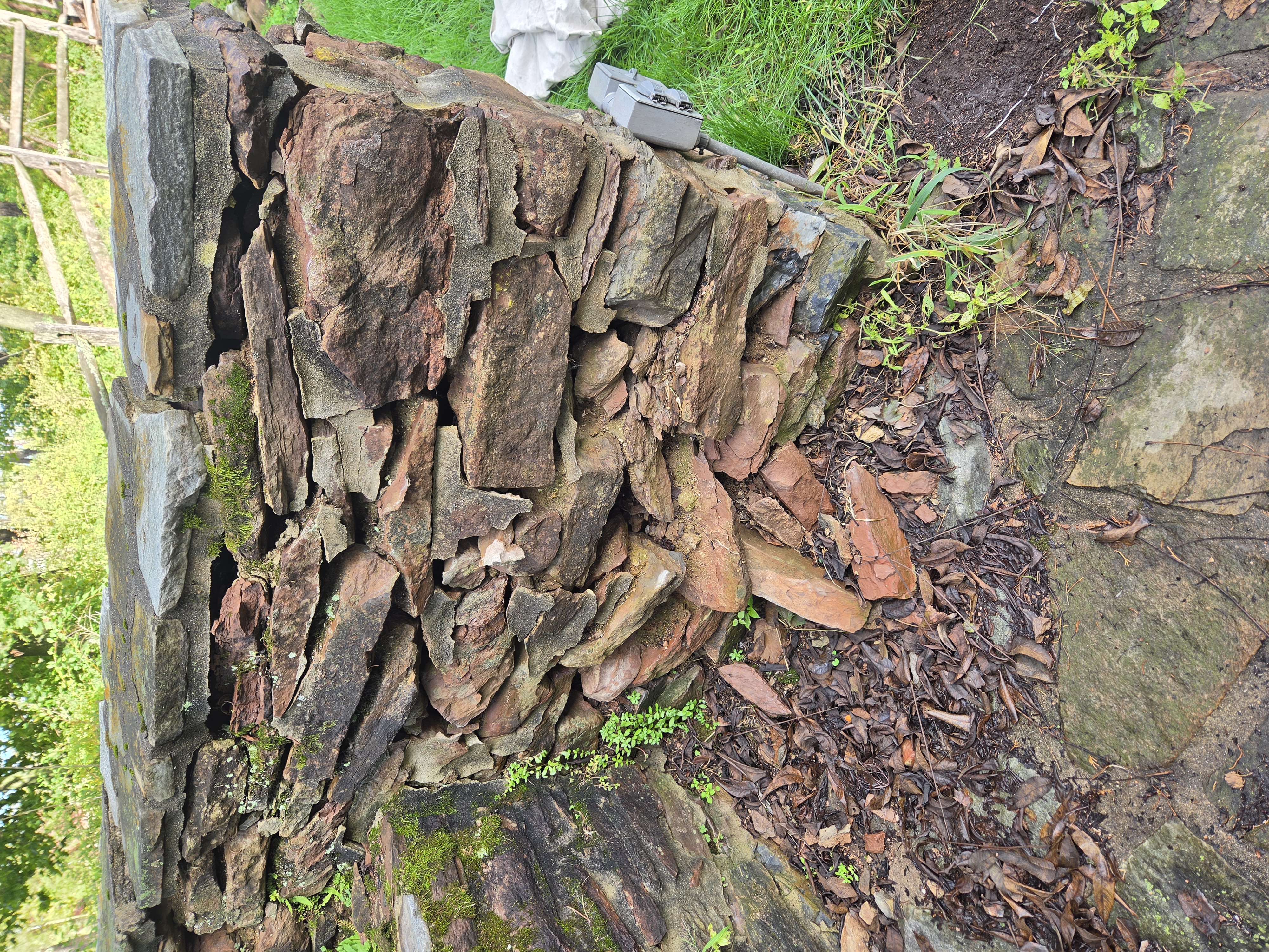 Damaged historic stone waterfall wall before restoration in Birdsboro PA