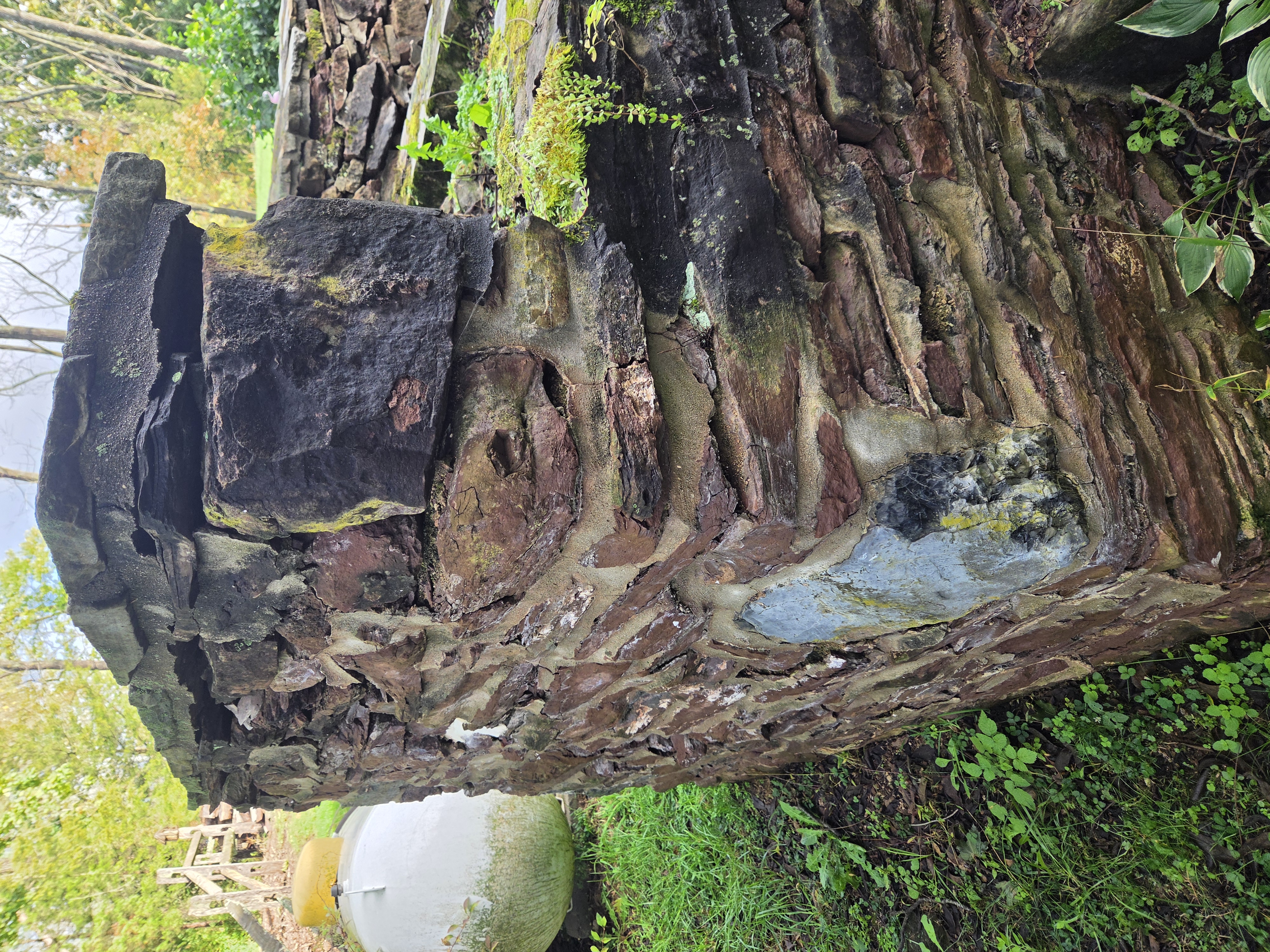 Historic stone waterfall corner with deteriorated mortar joints before repair