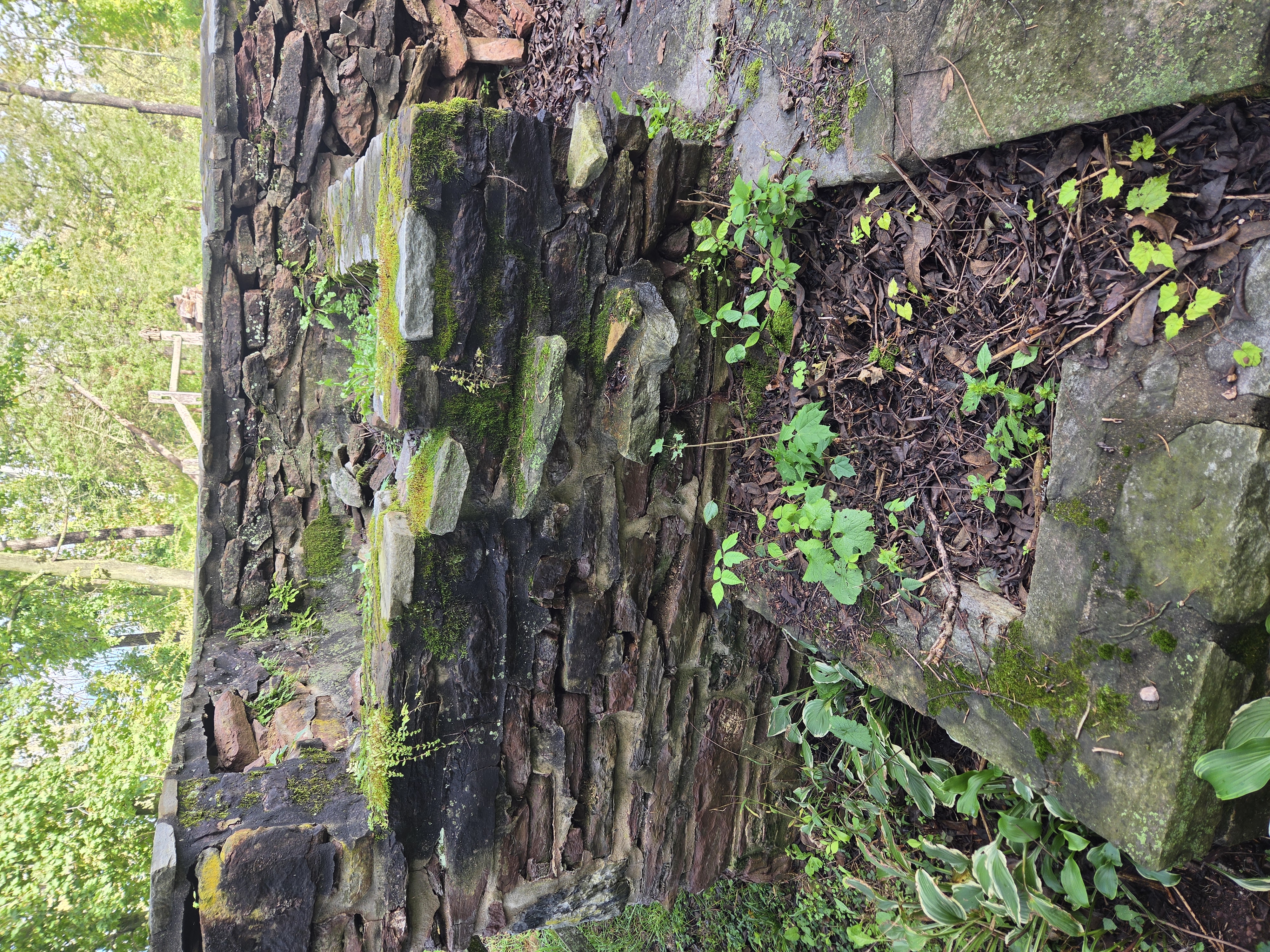 Historic natural stone waterfall structure before masonry restoration