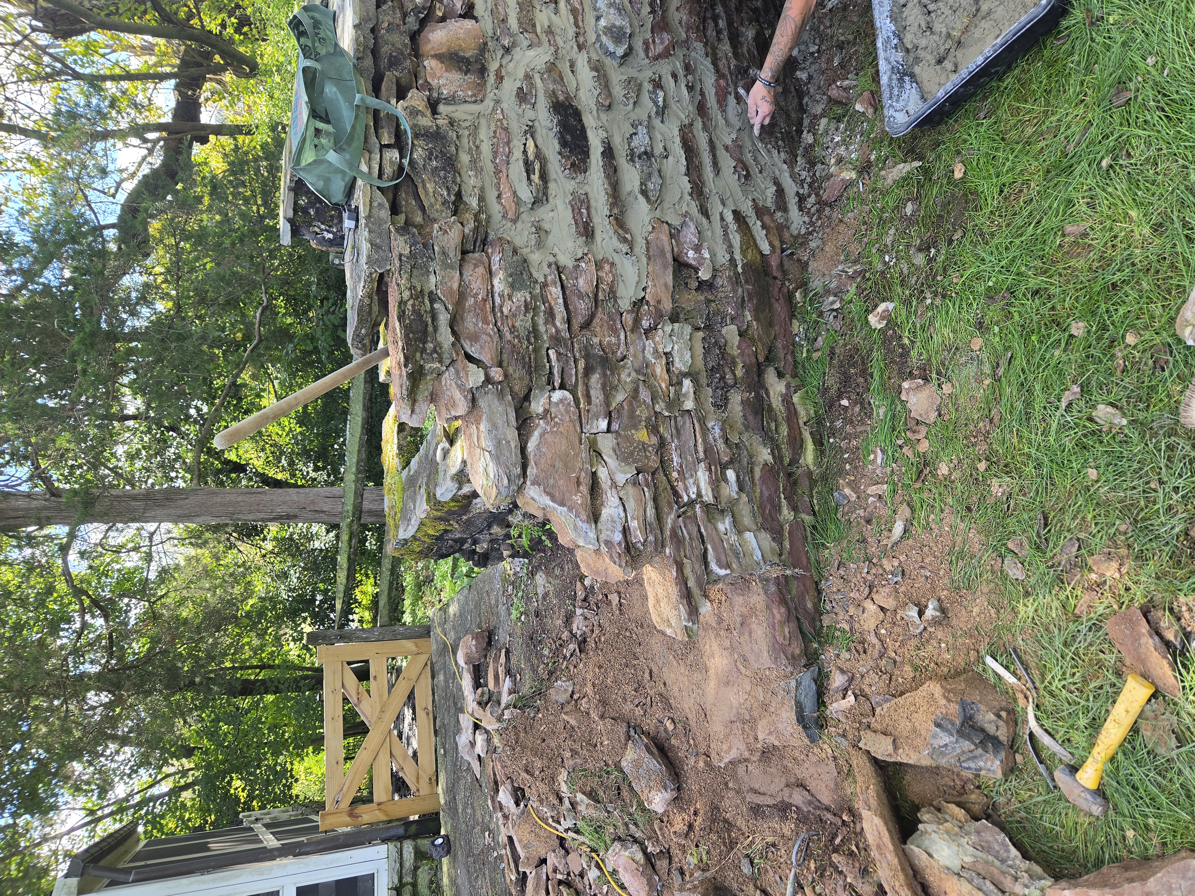 Stone masonry restoration in progress on historic waterfall in Birdsboro PA