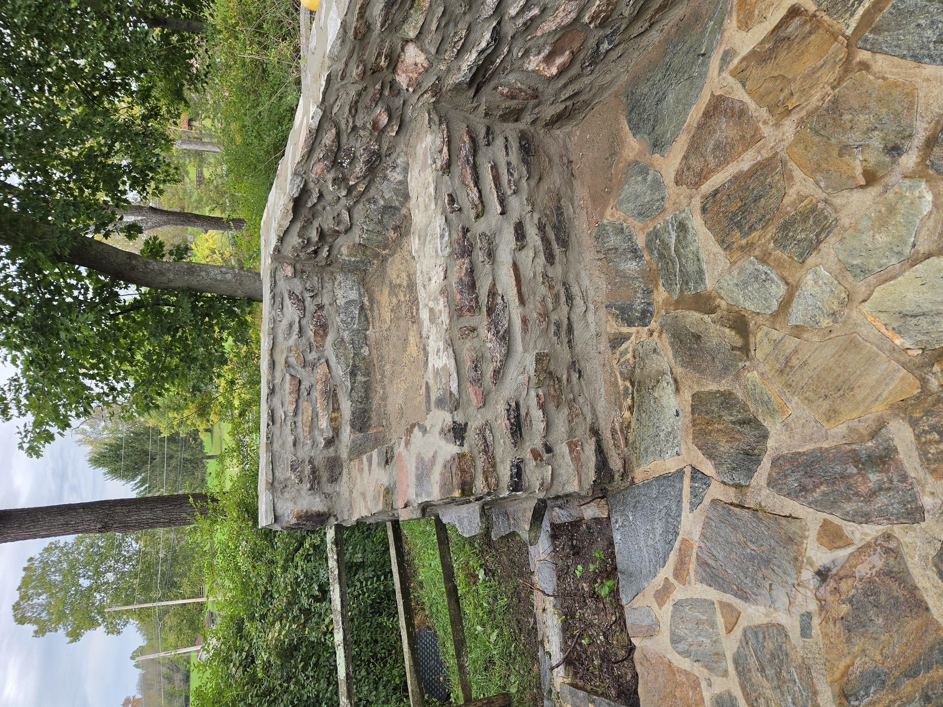 Restored natural stone waterfall with repaired masonry joints and stonework