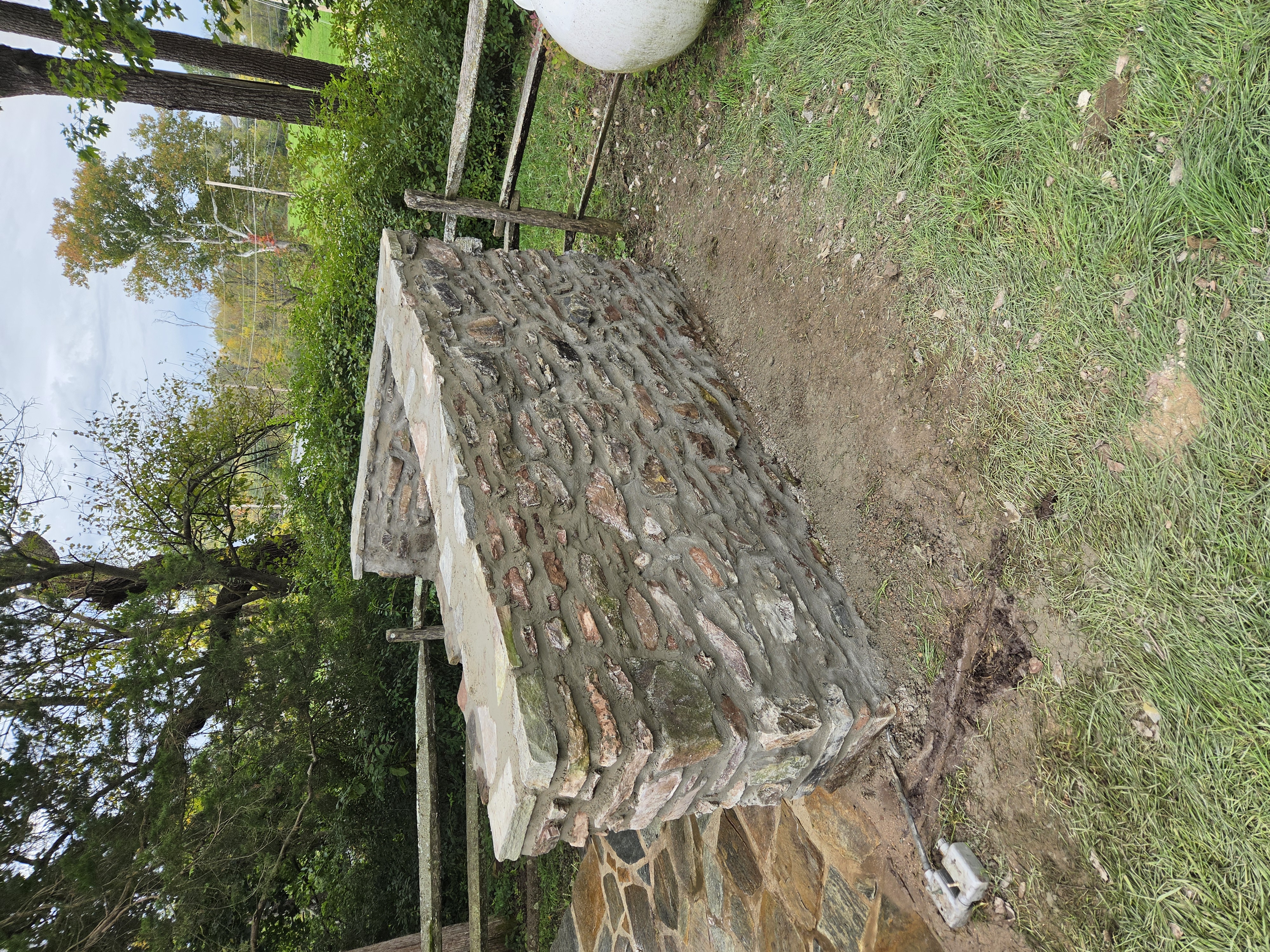 Restored historic stone wall showing repointed natural stone masonry